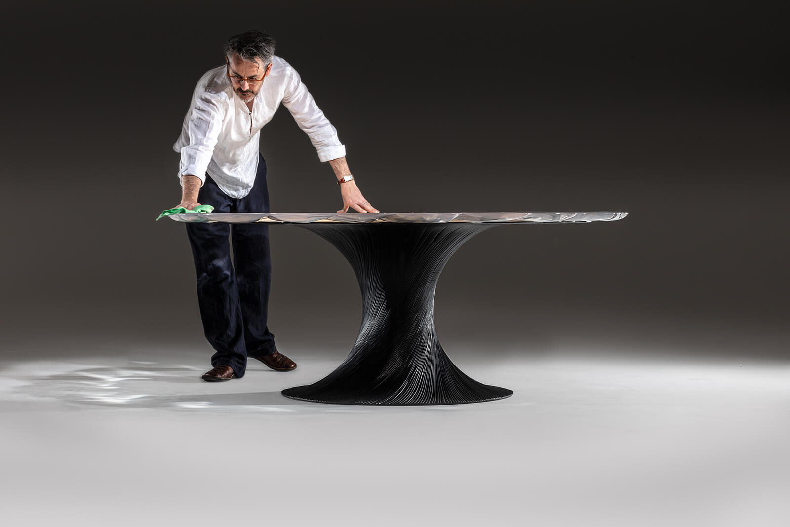 Marc Fish with ‘Vortex’ dining table, 2018 COURTESY: Marc Fish / PHOTOGRAPHER: Simon Eldon