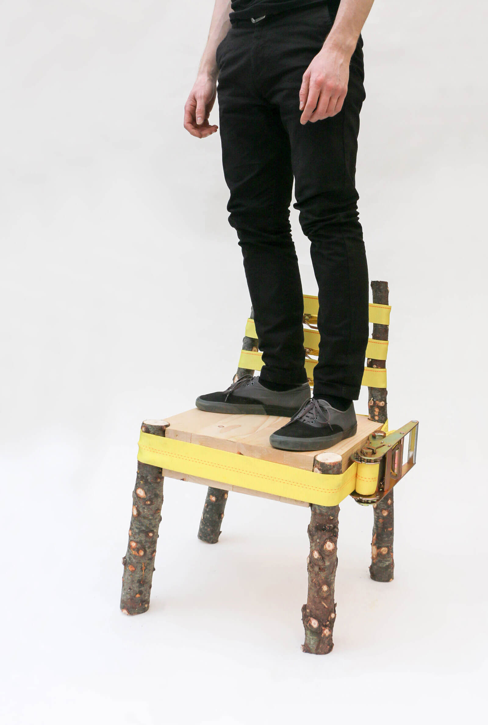 Nicholas Baker standing on 'Strap Chair' COURTESY: Nicholas Baker