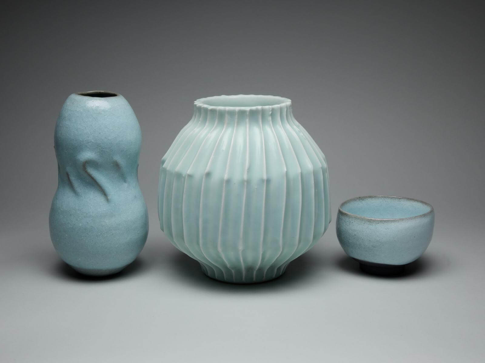 Shimizu Uichi, (left to right): ‘Pale Blue Glazed vase’, 1984; ‘Horai Sectioned Glazed Inscribed Jar’, 1980-1983; ‘Pale Blue Glazed Tea Bowl’, 1984 COURTESY: The Artist & Carpenters Workshop Gallery / PHOTOGRAPH: Callum Su