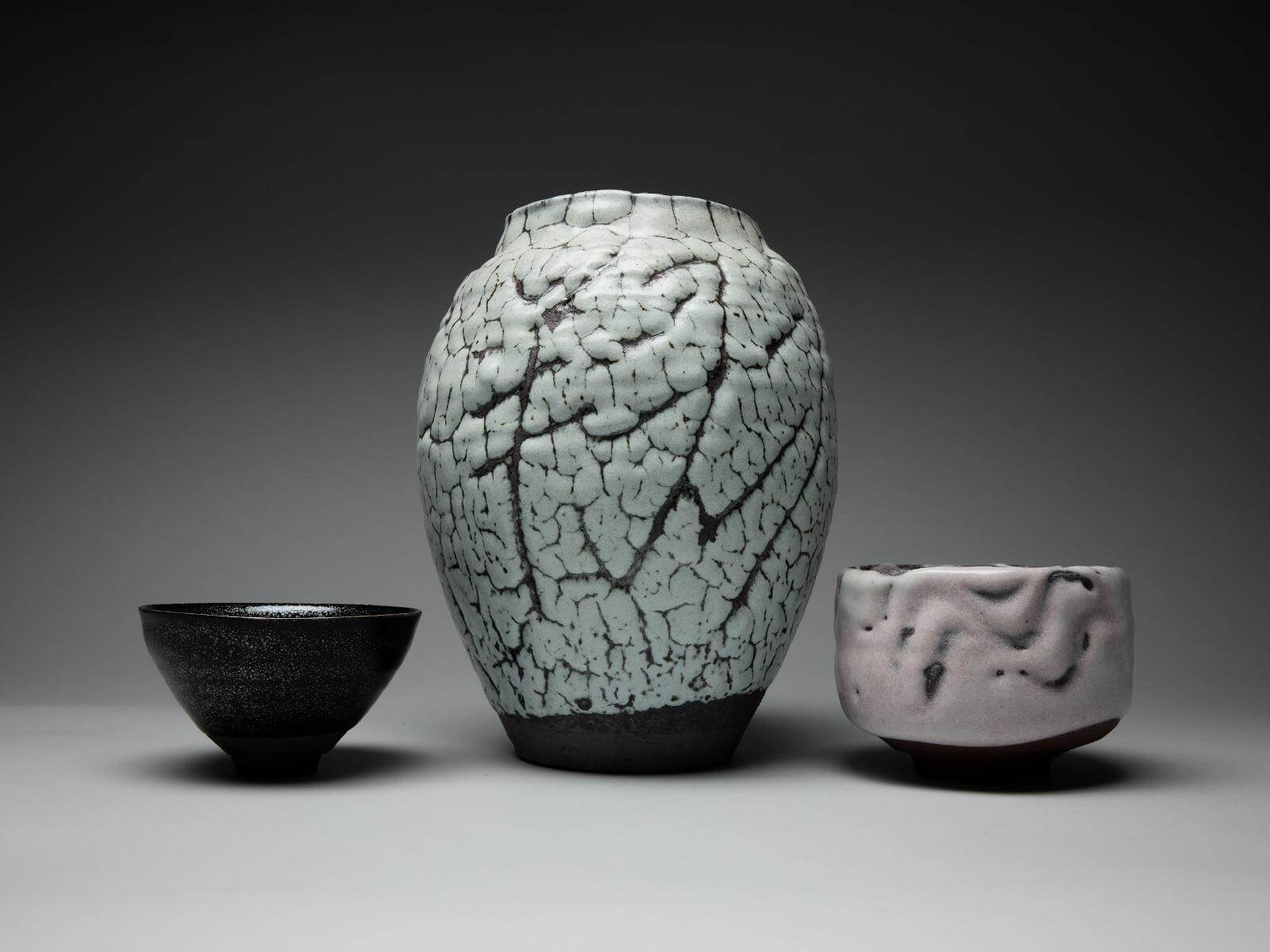 Shimizu Uichi, (left to right): ‘Iron-Glazed Oil-Spot Tenmoku Tea Bowl’, 1977; ‘Horai Craquelure-Glazed Inscribed Jar’, 1989-1991; ‘White-Flow Ash-Glazed Tea Bowl’, 1990-1996 COURTESY: The Artist & Carpenters Workshop Gallery / PHOTOGRAPH: Callum Su
