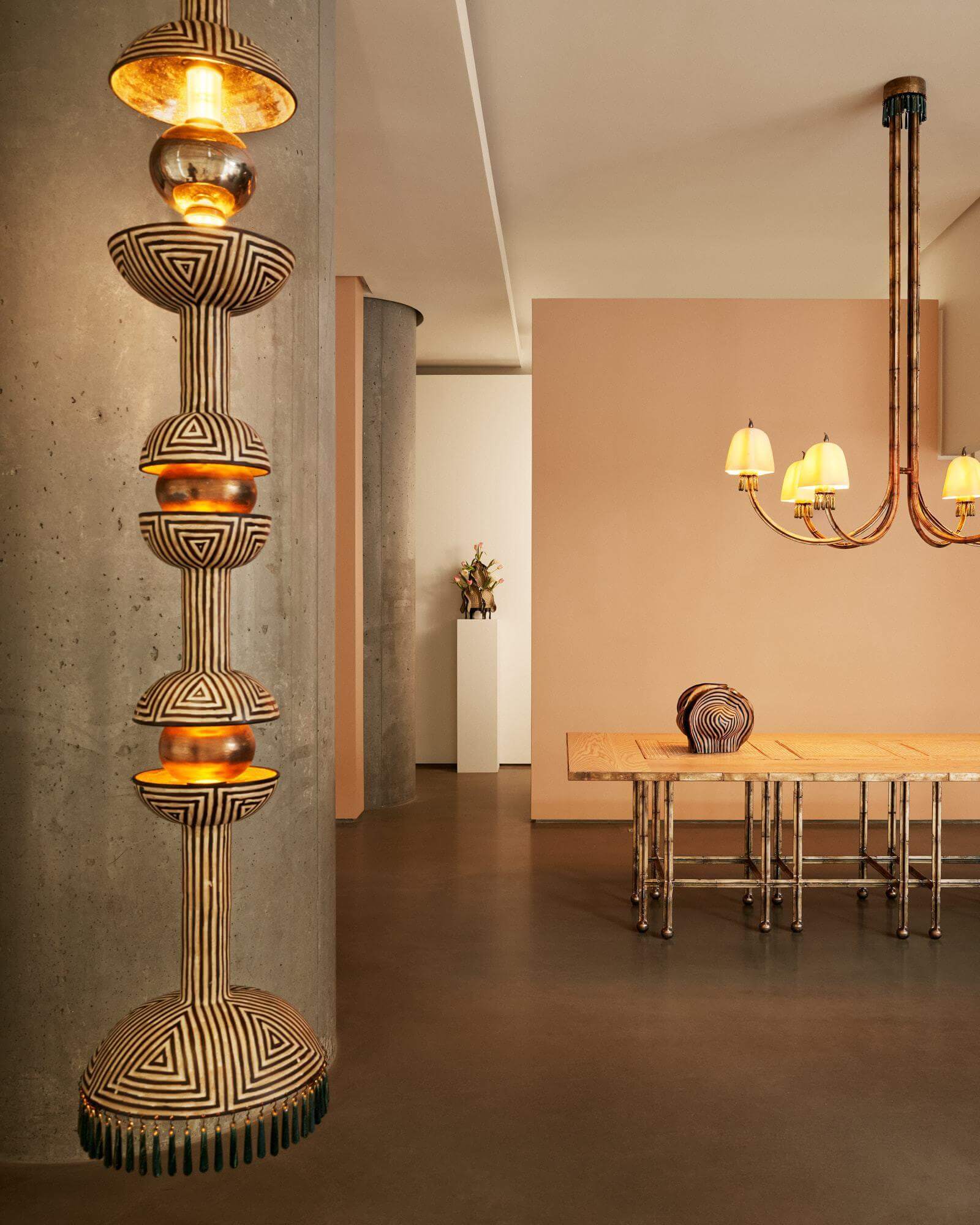 Exhibition view, ‘Held in Light’ with (left) ‘Space Relic (Brown and Ivory + Variegated Slate beads)’, 2026; (on table) ‘Piccolo 188’, 2026 COURTESY: © The Artist & Gallery FUMI