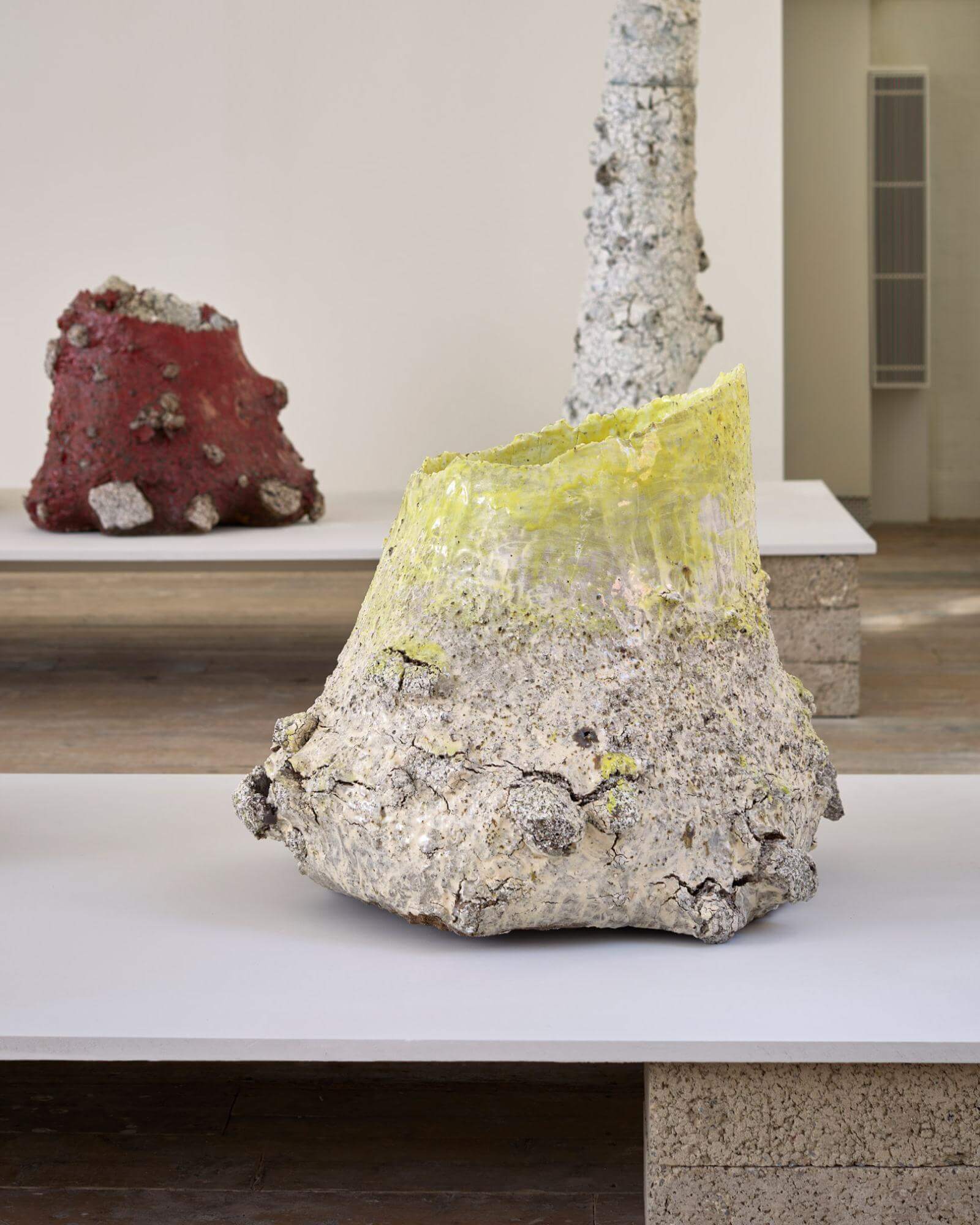 Exhibition view ‘Beneath the Skin’ by Aneta Regel with (foreground) ‘Raining stone (yellow & white)’, 2026; (background) ‘Raining stone (red)’, 2026 COURTESY: © The Artist & Sarah Myerscough Gallery / PHOTOGRAPH: © Gareth Hacker